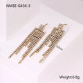 Gold electroplated stainless steel earrings with heart, star, and geometric shapes and a diamond tassel pendant.