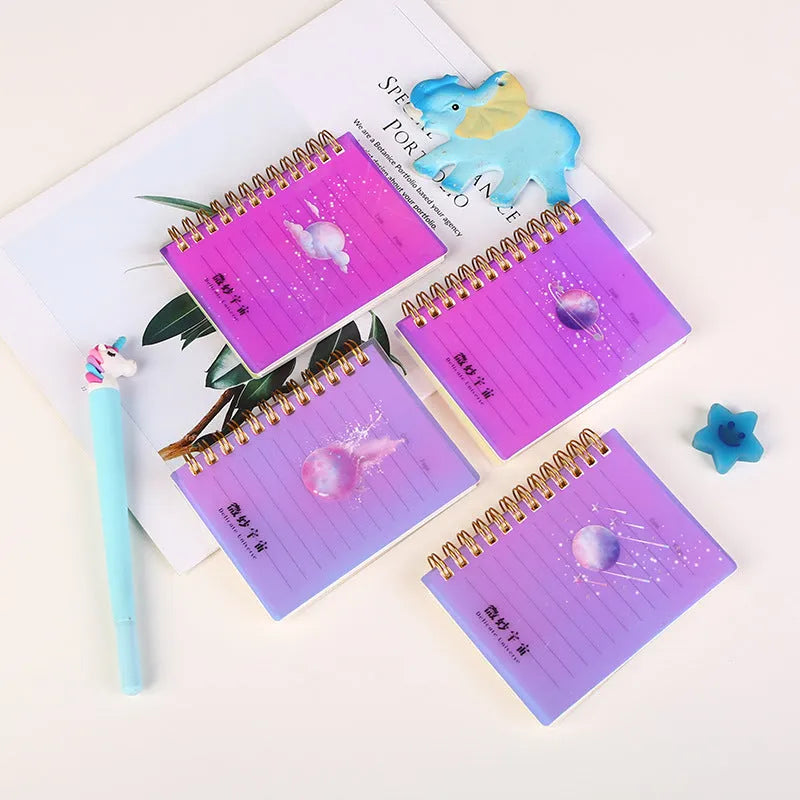 A7 rollover coil spiral notebook in four colours with spiral binding showing lay-flat pages