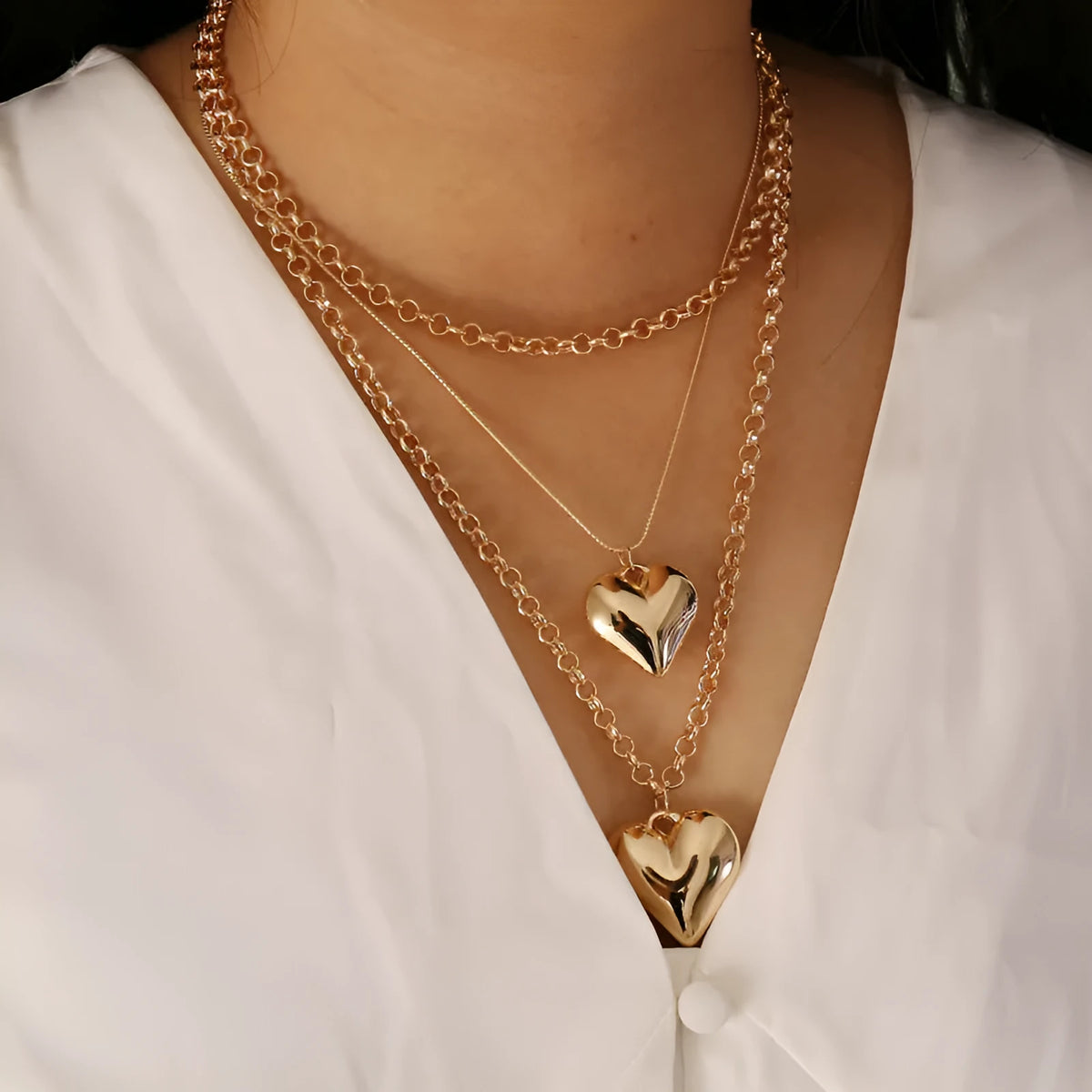 Gold multi-layer heart pendant necklace for women with alloy construction and electroplated finish.