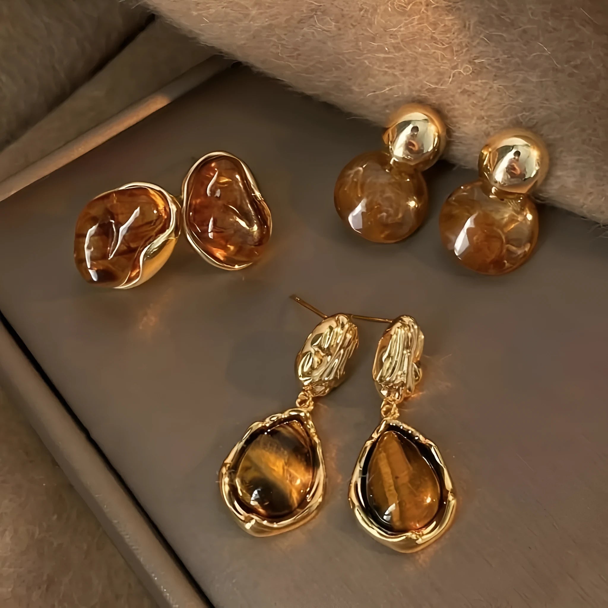 Three pairs of geometric tassel ear rings with electroplated alloy construction in different designs