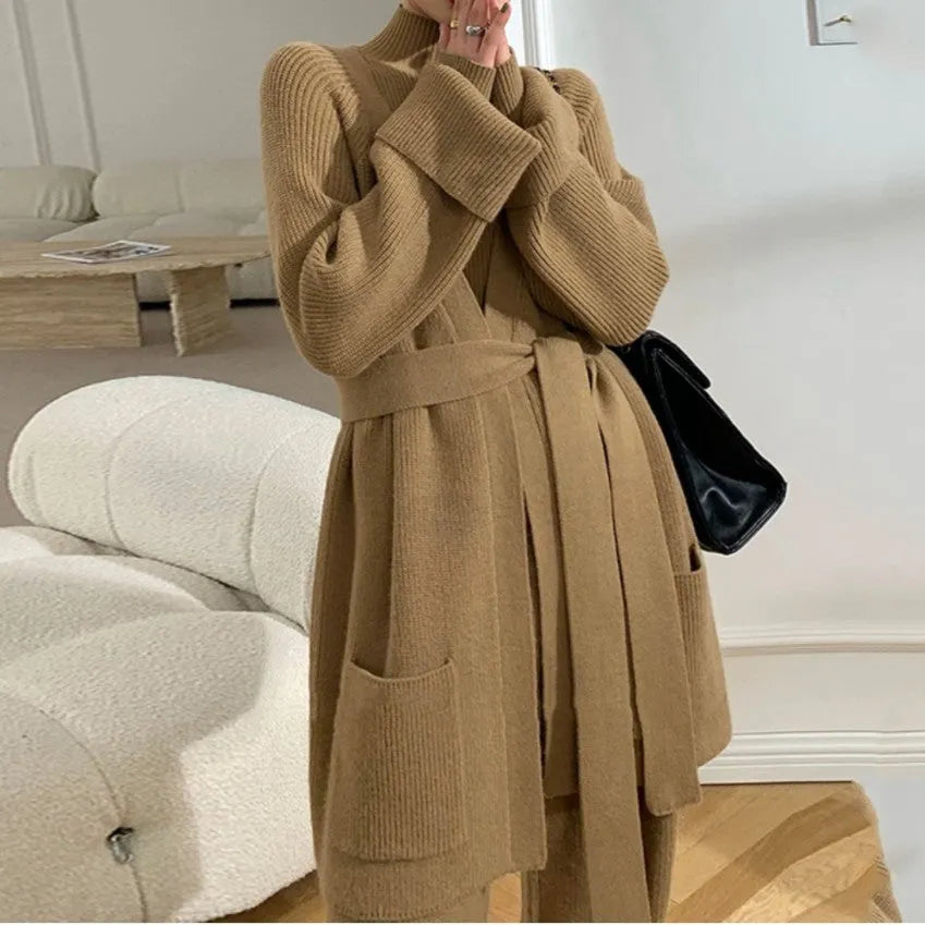 Women's apricot knitted three-piece set showing sweater, cardigan, and wide-leg pants with leather stitching detail.