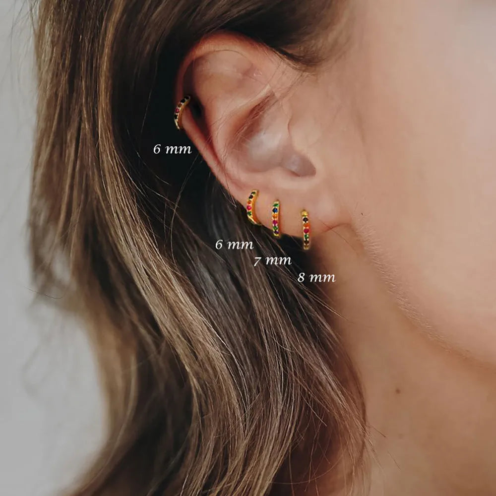 Circle zircon perforated stud earrings in gold, rose gold, and silver colours with geometric design