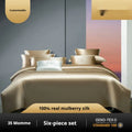 Solid colour silk quilt cover set on a bed, showing duvet cover and pillowcases in a champagne gold hue.