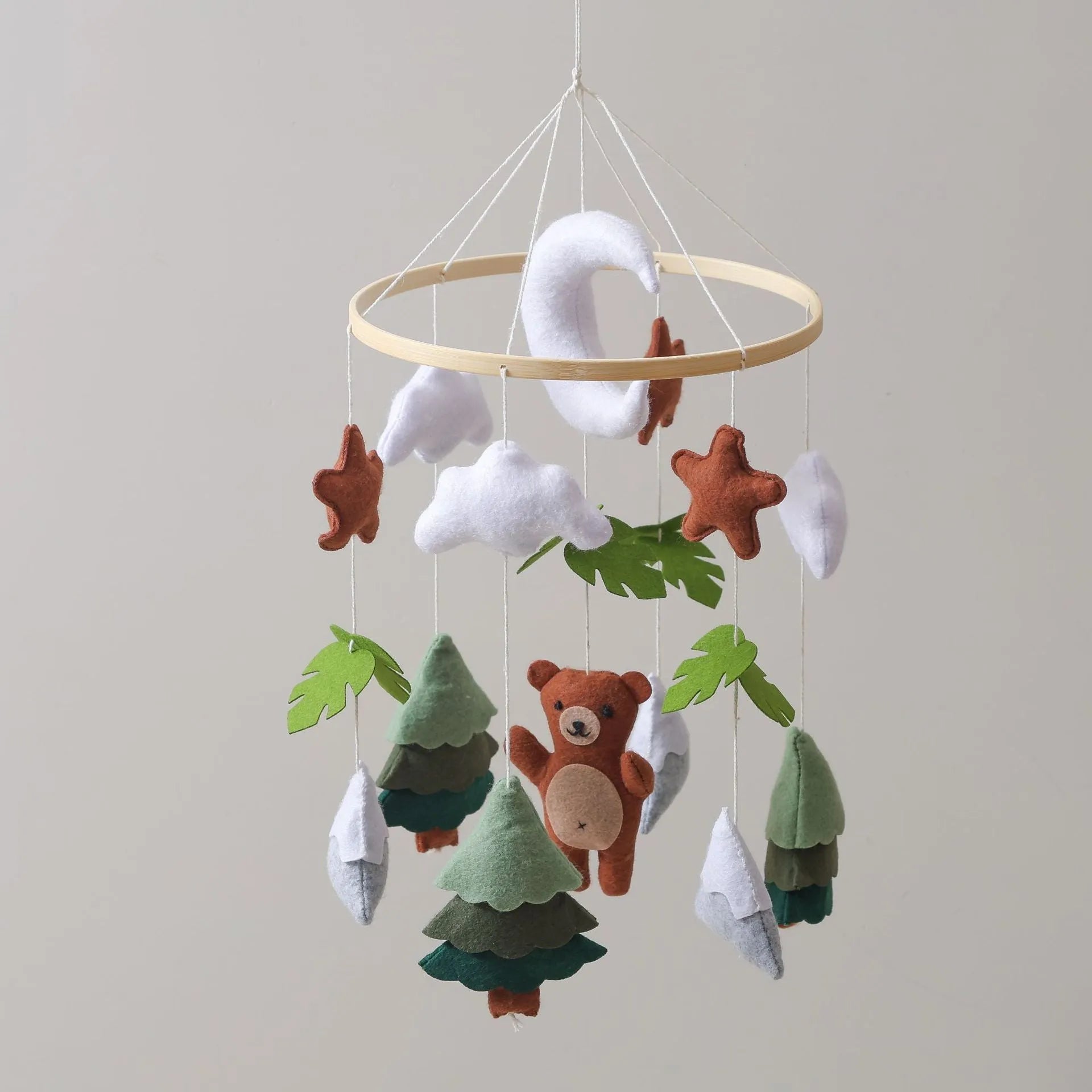 Handmade felt teddy bear bed bell in white on a wooden base for children's soothing sleep