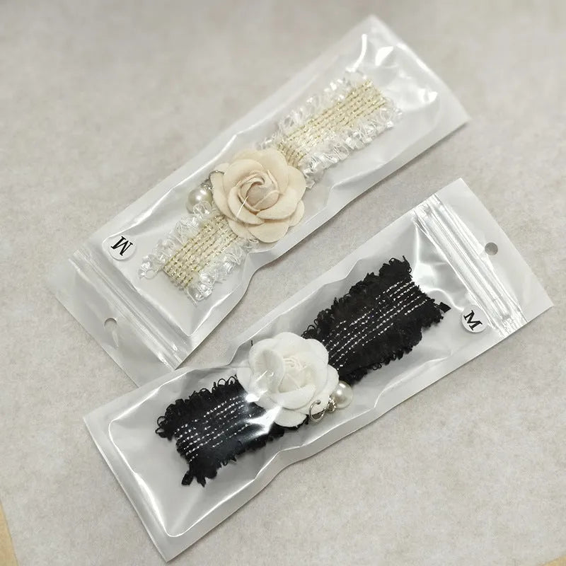Magnolia flower pet collar accessory with chain in black on white background