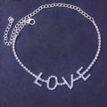 Gold letter anklet spelling LOVE with clear rhinestones on copper chain