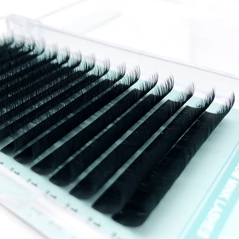 Soft velvet false eyelashes on a card, showing artificial fibre strands in various lengths.