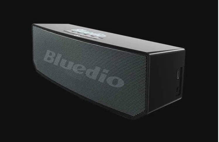 Black rectangular smart speaker with AI voice assistant, showing front grille and micro-USB port.