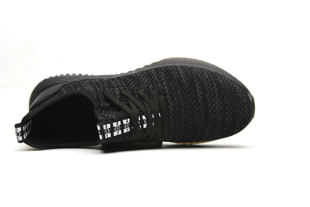 Black low-cut safety work shoes with a visible steel toe cap, shown on a grey background.