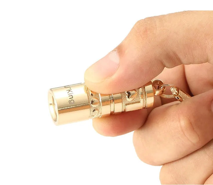 Gold waterproof LED flashlight keychain with zinc alloy die-cast housing and polished finish
