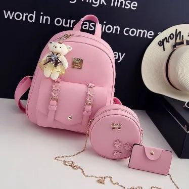Women's 3-piece floral print PU leather bag set showing backpack, shoulder bag, and card purse in pink.