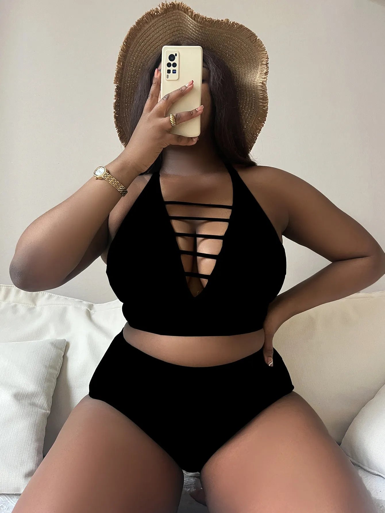 A plus size woman modelling a solid colour halter bikini with adjustable cross-back straps and high-waist briefs.