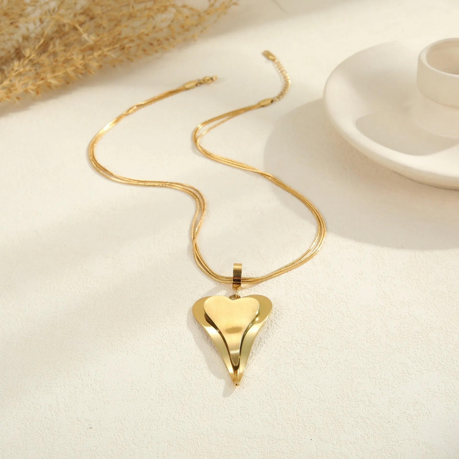 Stainless steel double heart necklace with snake chain design and geometric pendant