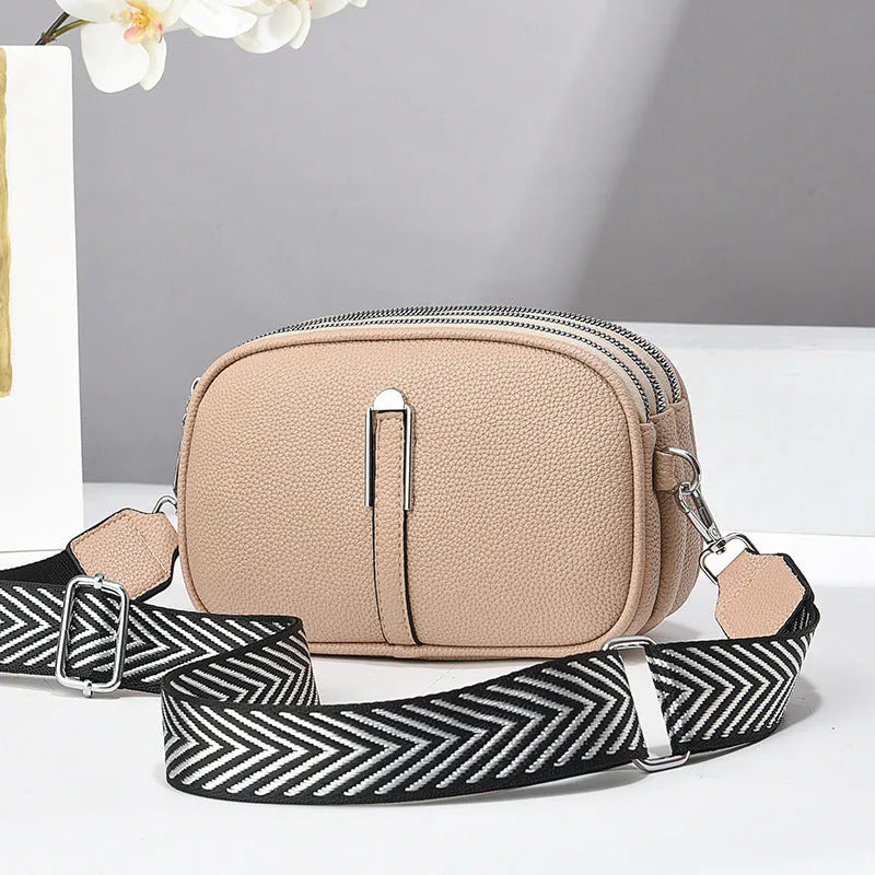 Women's soft PU crossbody bag in oval shape with interior organisation compartments