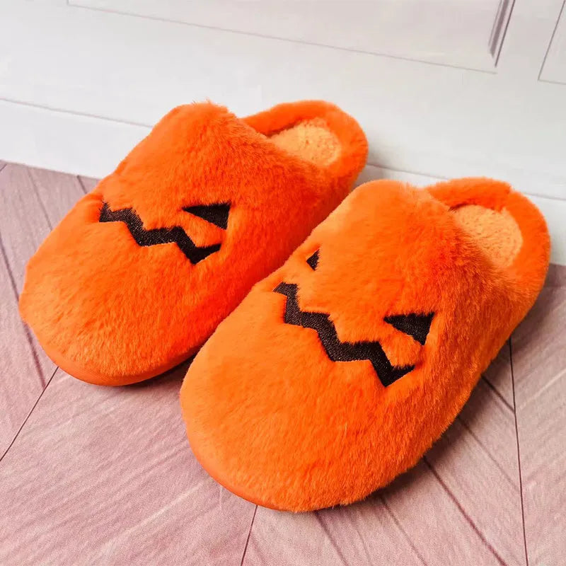 Orange plush Halloween pumpkin slippers with coral velvet upper and flat PVC sole.
