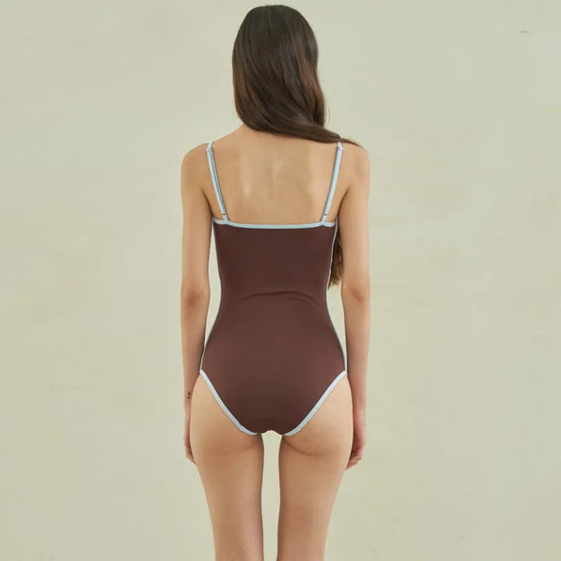 Brown nylon triangle one-piece swimsuit for women on a hanger