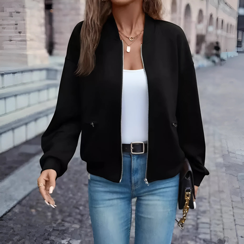 Black women's casual zip jacket with long sleeves on a hanger.