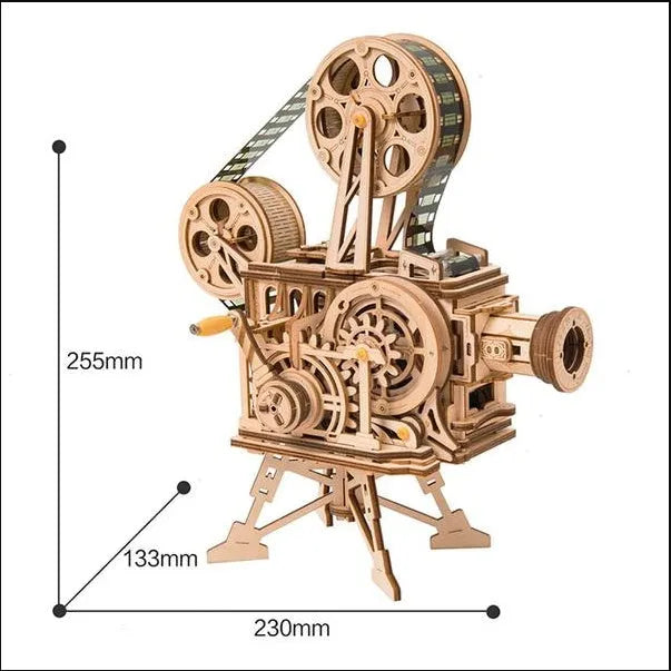 Flat-packed wooden 3D puzzle film projector with visible gear wheel assembly and hand crank