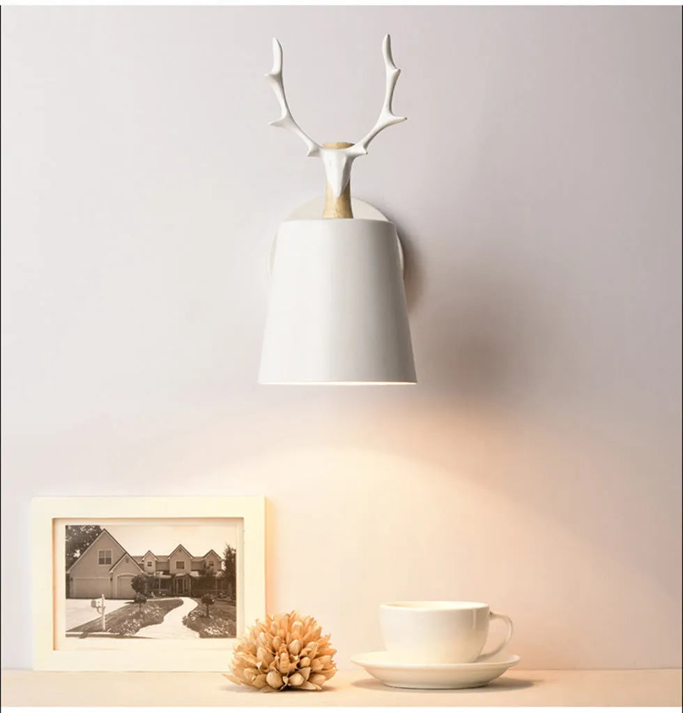 Modern antler wall lamp in black finish with iron and wood construction, measuring 24x29cm
