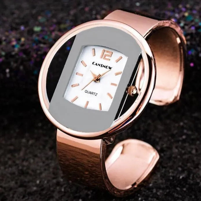 Women's adjustable cuff bracelet watch with 40mm dial, steel band, and choice of gold or silver finish
