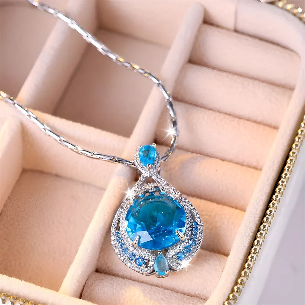 Blue geometric crystal pendant necklace on a silver water wave chain for women