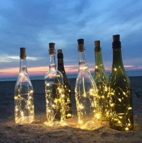 Silver copper wire LED string light with bottle stopper for decorative lighting.