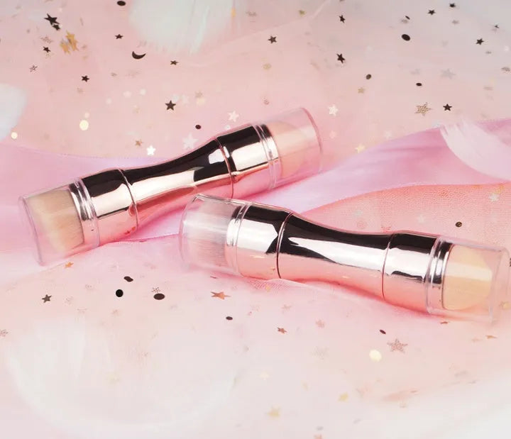 Four-in-one retractable makeup brush with gold handle and four brush heads on a white background