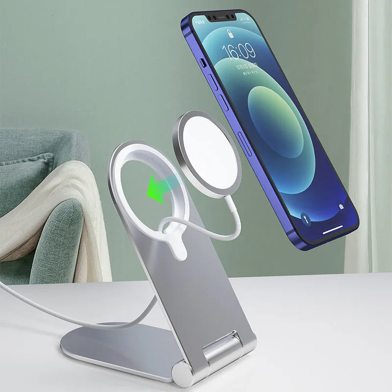 Silver vertical adjustable magnetic phone bracket for iPhone 12 series on a flat surface.