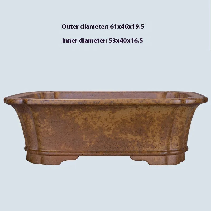 A large rectangular purple sand mud flowerpot with angled segment design on a floor.