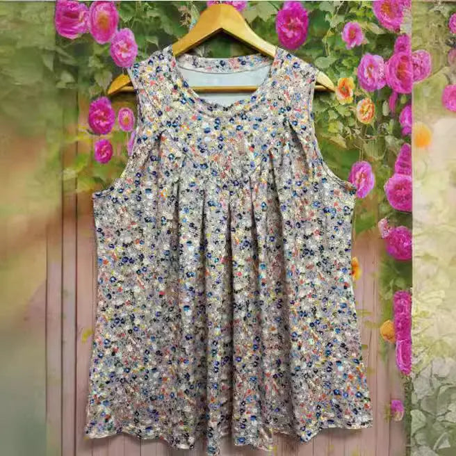 Plus size black floral print sleeveless vest with round neckline on a hanger.