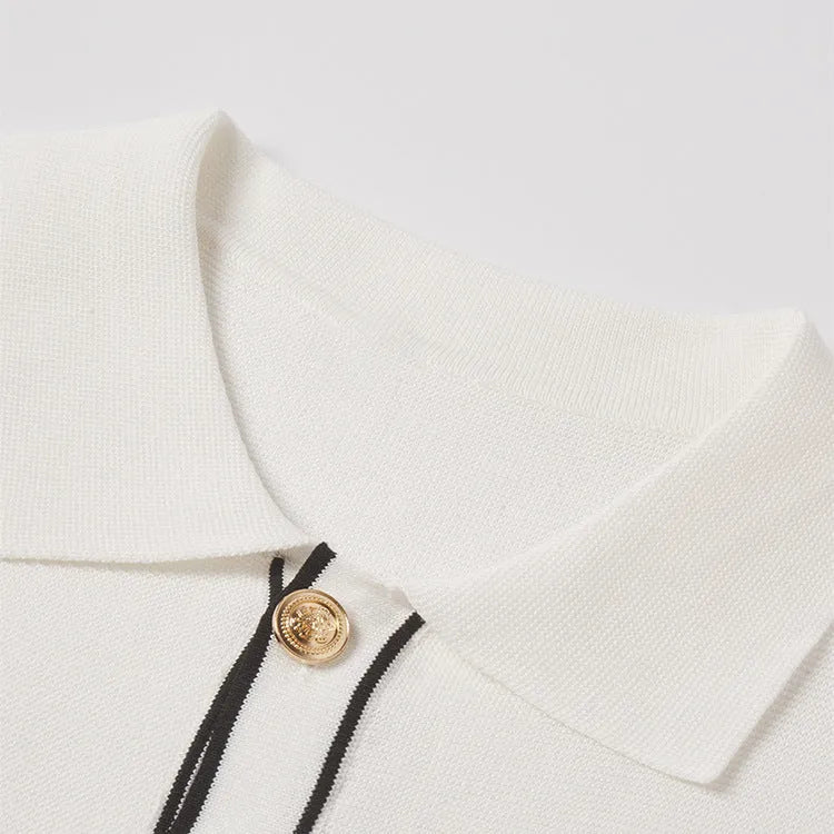 White short sleeve cardigan with dark contrast lapels laid flat.