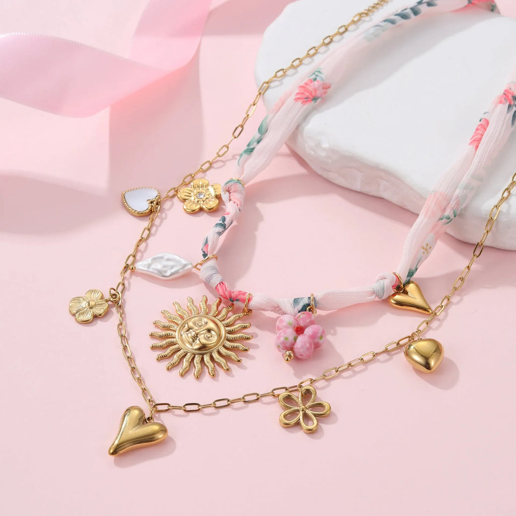 Stainless steel necklace with an 18K gold electroplated geometric pendant on an adjustable chain.