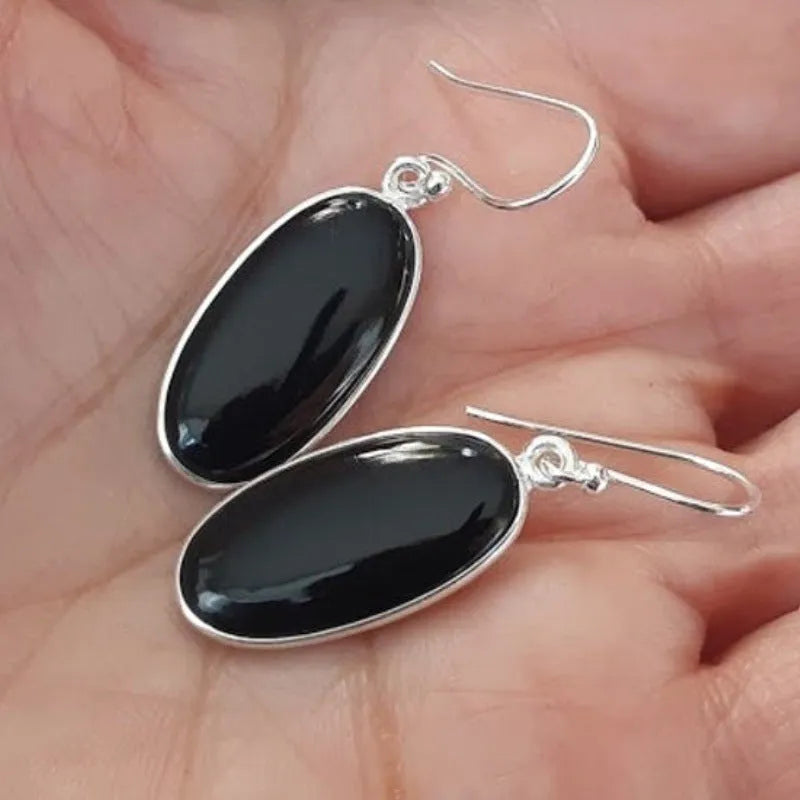 Women's geometric drop earrings with oval black agate pendant in silver setting