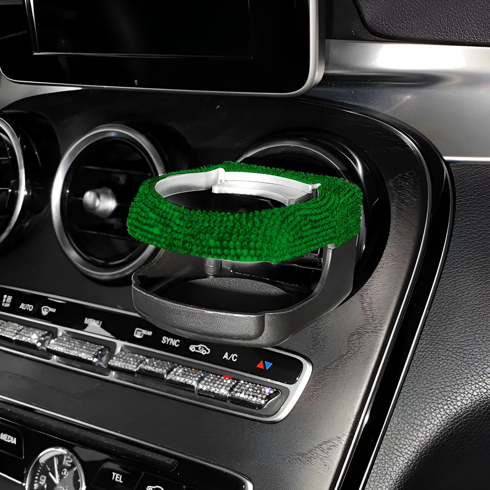 White diamond rhinestone car air vent cup holder bracket on a grey car dashboard.