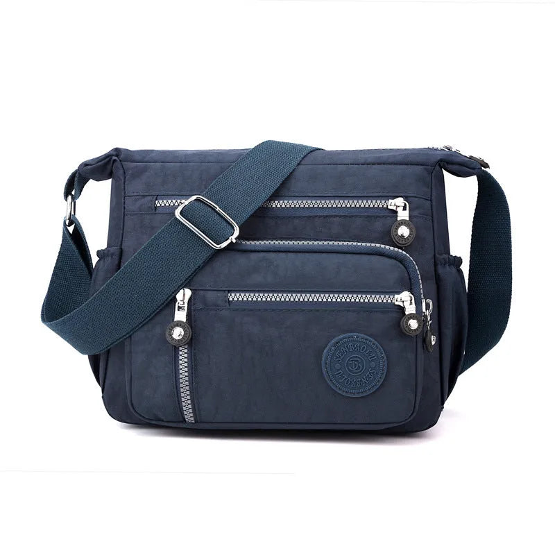 Soft nylon shoulder messenger bag in square vertical design, shown in grey colour.