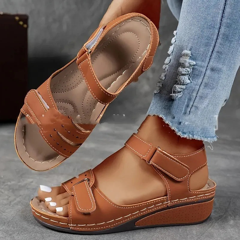 Women's beige strap sandals with a thick composite sole and adjustable Velcro fastening.