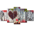 Set of five red unframed canvas wall art prints in graduated sizes arranged on a wall.