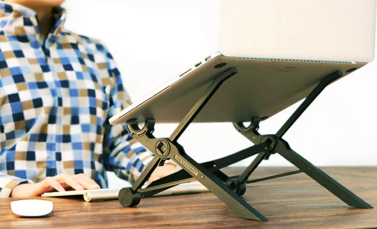 Black reinforced nylon folding laptop stand shown open in use and collapsed for storage.