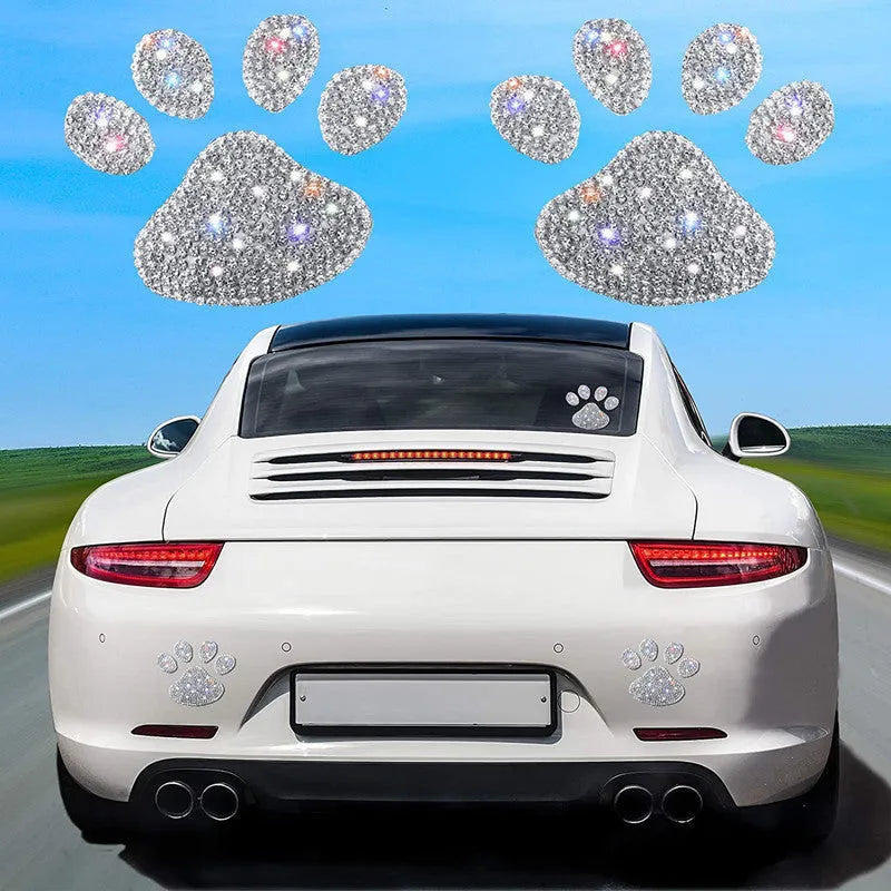 Glass car sticker with diamond-encrusted bear paw or butterfly design on white background.