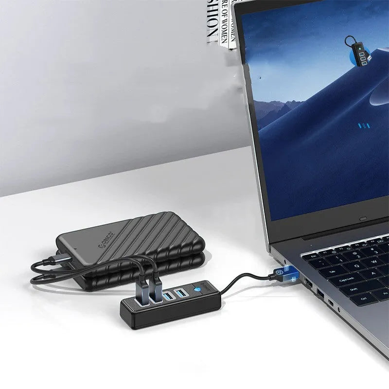 Black ABS 4-port USB 3.0 hub with USB-A input and multiple cable lengths for notebooks