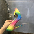 Rainbow multicolour patent leather women's high heel shoe with thin heel and pointed toe.