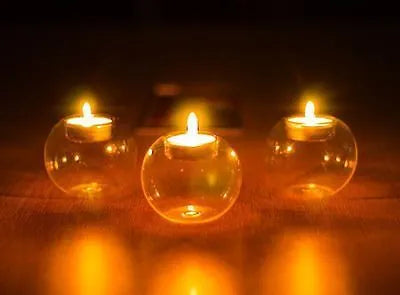 Clear round hollow handmade glass candle holder in European style on a table