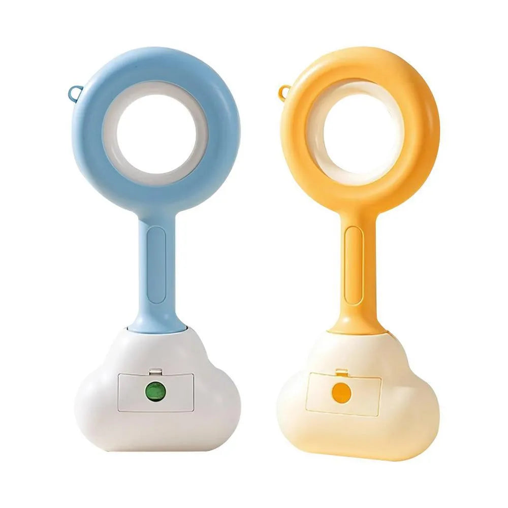 White blue dog pooper scooper with cloud-shaped jaw design on grass