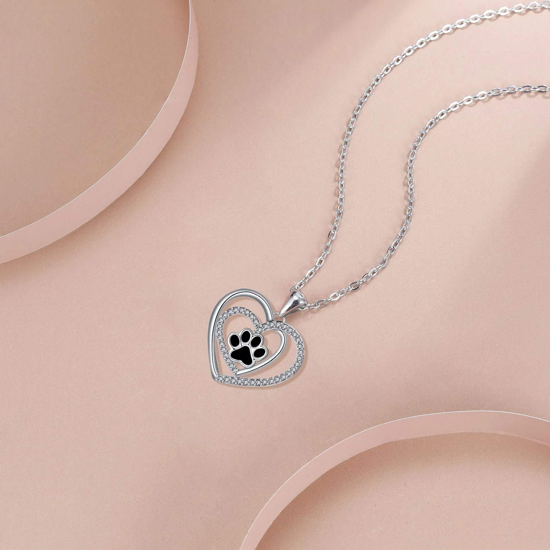 Women's necklace with heart-shaped dog paw pendant on cross chain