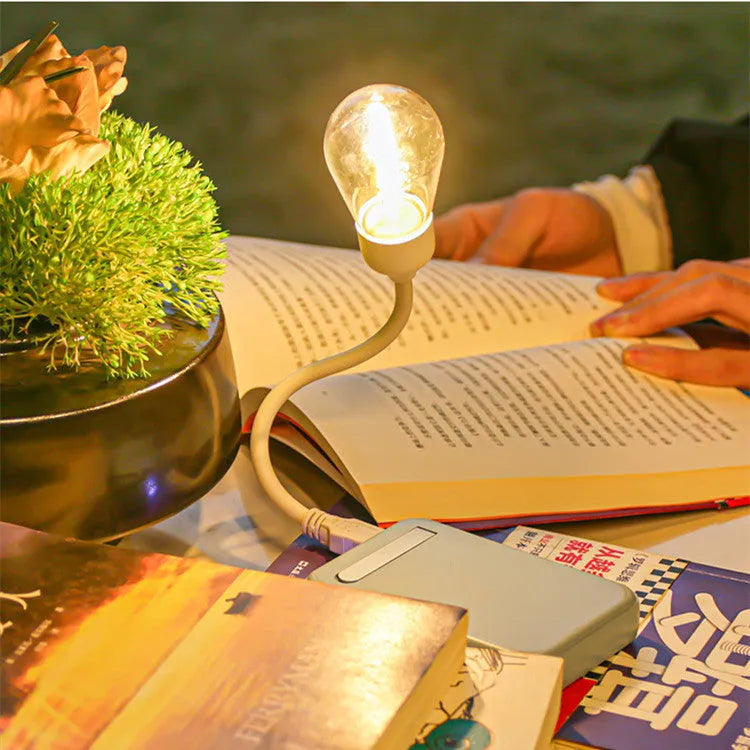 USB rechargeable folding night light with warm tungsten bulb illuminated.