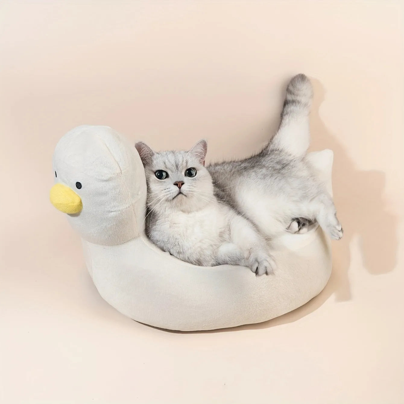 Blue duck-shaped soft polyester pet bed sofa for small dogs and cats on a wooden floor.