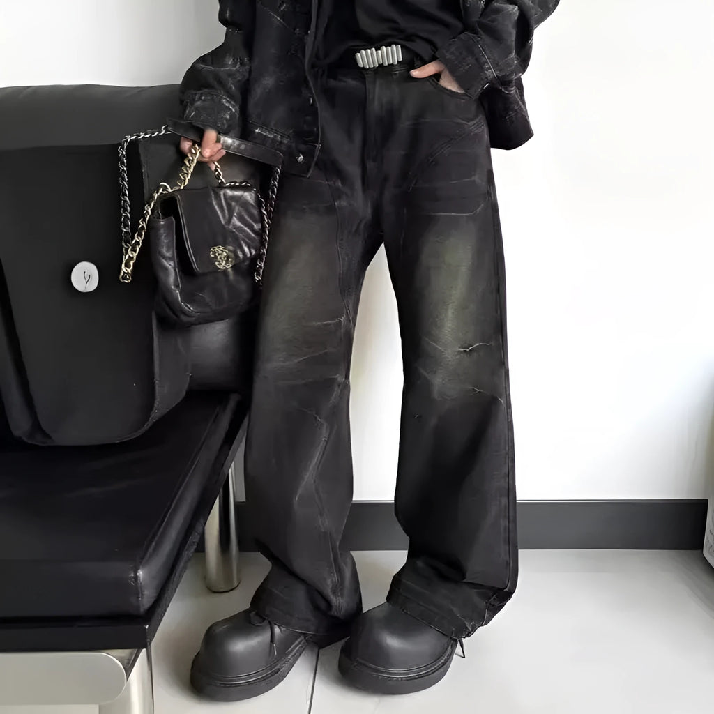 Washed black straight denim trousers with deconstructed dirty mud texture and zipper fly