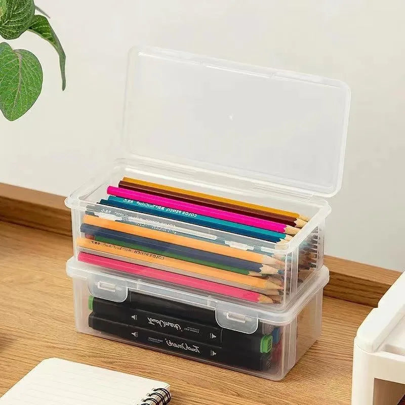 Large transparent plastic stationery storage box filled with coloured pencils and pens
