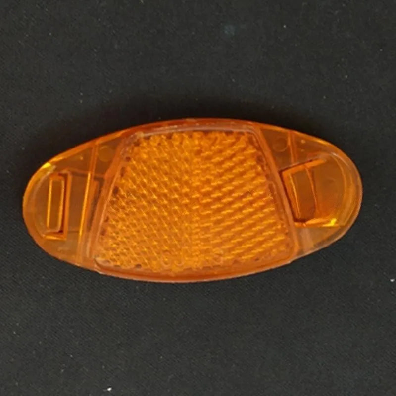White and yellow plastic bicycle spoke reflectors measuring 7.2cm long by 3.5cm wide for night safety