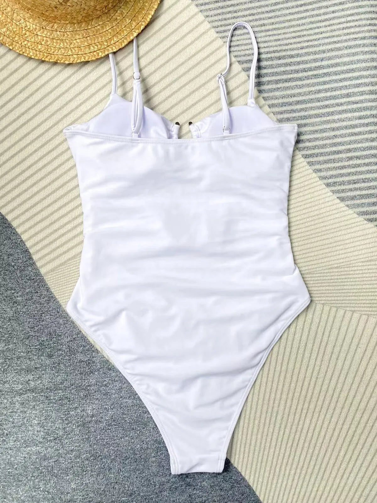 Black women's one-piece swimsuit on hanger showing form-fitting nylon design